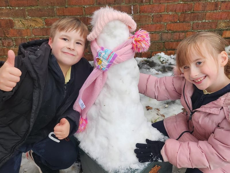 Zachary and Scarlett with their snowman