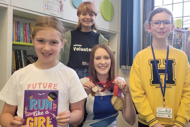 North Yorkshire-based Paralympian and author Danielle Brown with her gold medals and an honorary Ready, Set, Read medal. Beth Kent, 12, and Emily Scott, 16, with Summer Reading Challenge participant Lucy Browne, seven, who holds Danielle's book, Run Like a Girl.