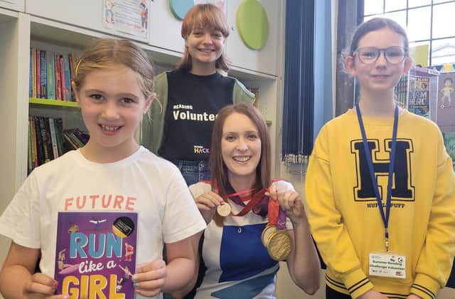 North Yorkshire-based Paralympian and author Danielle Brown with her gold medals and an honorary Ready, Set, Read medal. Beth Kent, 12, and Emily Scott, 16, with Summer Reading Challenge participant Lucy Browne, seven, who holds Danielle's book, Run Like a Girl.