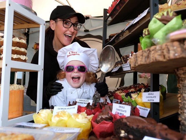 Little chef Imogen with a range of cupcakes.