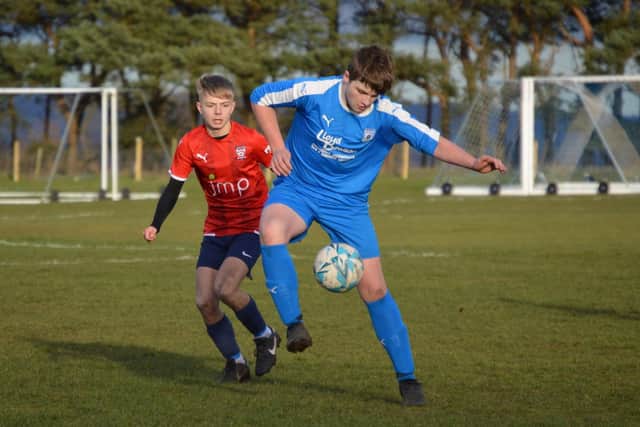A Heslerton Under-16s player gets the ball under control