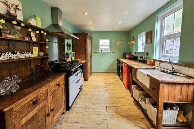 The extensive kitchen with diner has wooden units and worktops.