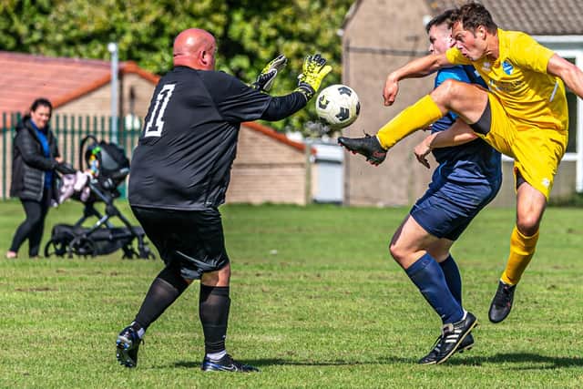Whitby Fishermen's Society Academy keeper Paul Cull stops a Ryedale effort.