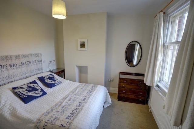 One of the double bedrooms within the house, all of which have windows with views over countryside, and to the coast.