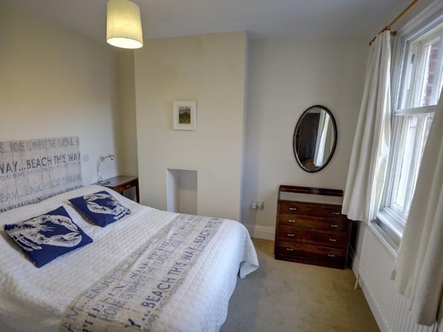 One of the double bedrooms within the house, all of which have windows with views over countryside, and to the coast.