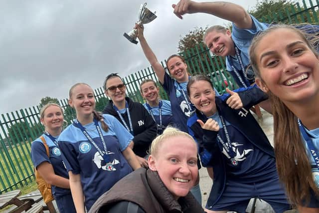 The Scarborough Sirens celebrate their trophy success.