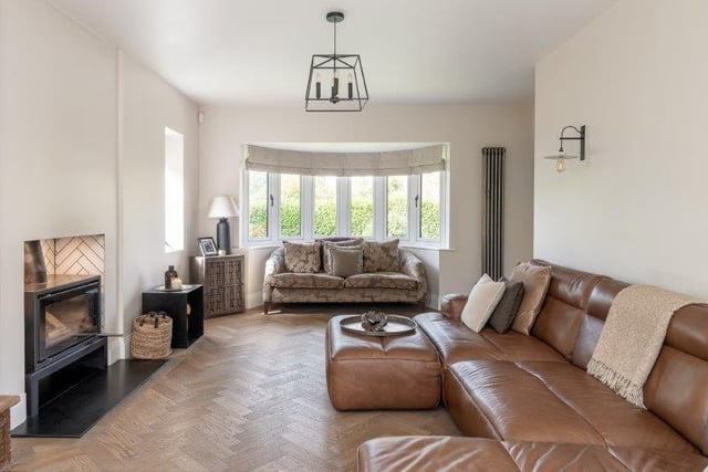 The bay-windowed lounge with log burner attracts plenty of natural light.