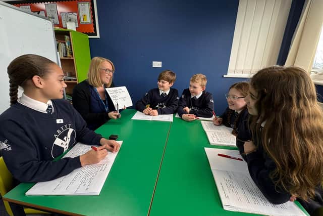 Teacher, Mrs Karen Plumpton, celebrates with pupils after receiving national praise from the Government for their exceptional results, placing the school among the very best in the country.