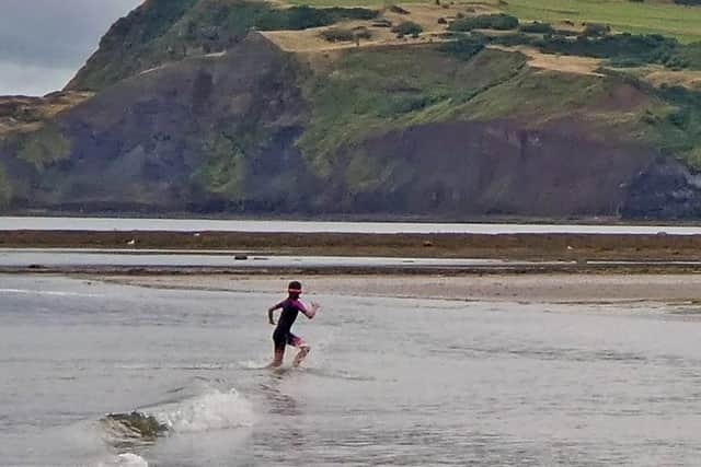 Racing the waves at Robin Hood's Bay.