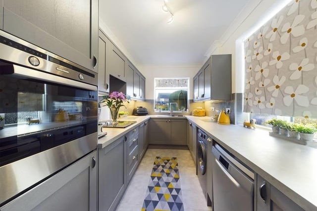 This modern fitted kitchen is on the ground floor, along with a lounge, dining room, a large conservatory and a w.c..