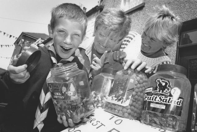 At the Filey Edwardian Street Party in Queen Street, Filey, sweet-toothed cub scout Mark Womersley, pictured with his mum Lesley, and friend Susan Pinder, right, take charge of the Filey Scouts stall. The street party took place back in July, 1995. 
