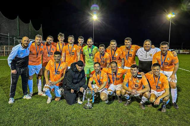 Edgehill and kit sponsor Darren Hodgson of Wonderwall Plastering line up with the North Riding FA Saturday Challenge Cup after beating Carperby 4-0.