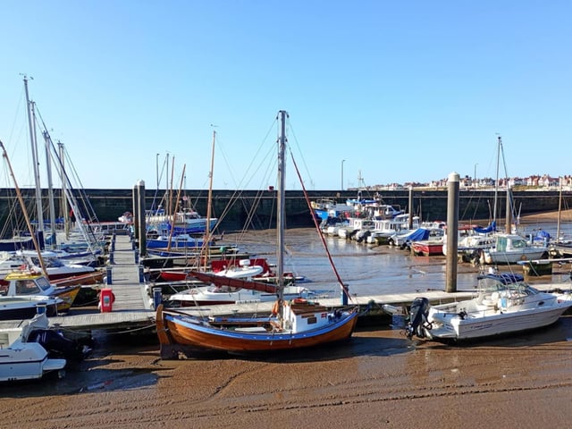 Shelagh E Wallace frames harbour boats during a low tide.