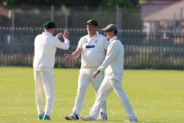 The home side celebrate claiming a Scalby 2nds wicket.