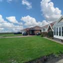 The well placed bungalow looks out to a seascape.