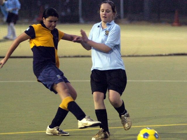 Pindar take on Filey (blue) in secondary schools girls' football match. 090327a