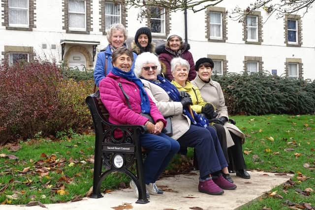 Filey Convent Old Girls’ Association Committee members meet to try out their seat in the old Convent grounds.