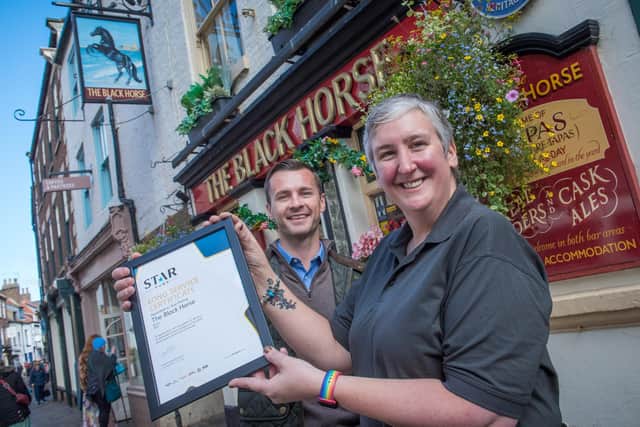 Sue Paling of the Black Horse gets her long service award from Matthew Williams from Star Pubs.