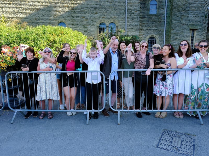 Families cheer the arrival of students.