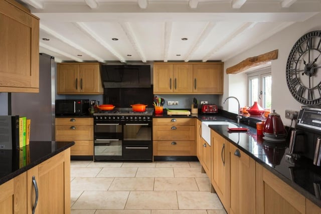The oak fitted kitchen has granite worktops and high quality integrated appliances.