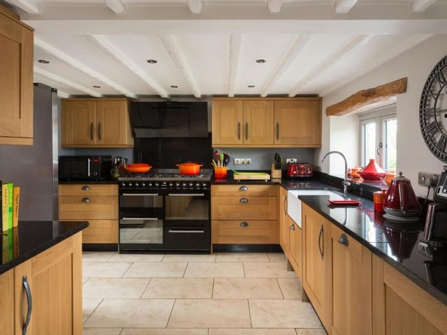 The oak fitted kitchen has granite worktops and high quality integrated appliances.