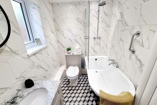 A fully tiled and stylish bathroom.