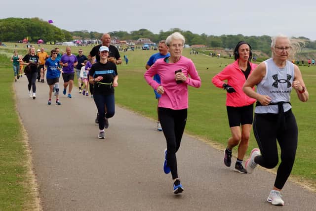 Janet Potter, of Bridlington Road Runners,centre, wearing pink top, enjoys the Sewerby parkrun. Photo by Kirsty Dew (TCF Photography)