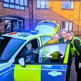residents and visitors enjoying a closer look at the visiting police car