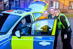 residents and visitors enjoying a closer look at the visiting police car