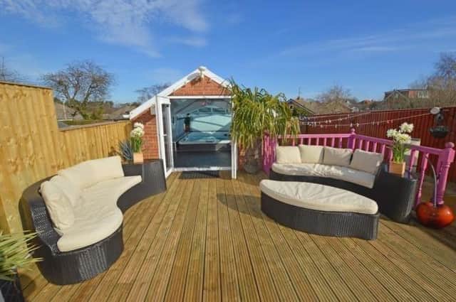 A deluxe spa pool accessed from a decked seating area in a private garden is one of the facilities with this property for sale in Newby.