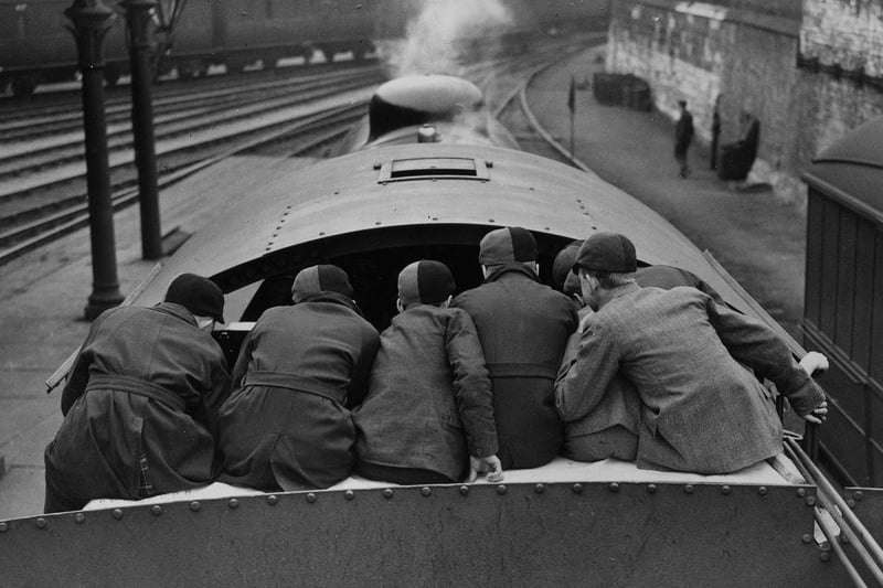 A group of schoolboys sitting on the tender of the latest LNER Shire engine at the LNER Museum, York in April 1933. They are being given a demonstration of engine-driving by a professional, one of the features at a special Railway Exhibition.