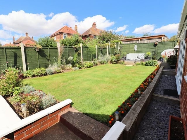 The lawned and enclosed rear garden has established planted borders.
