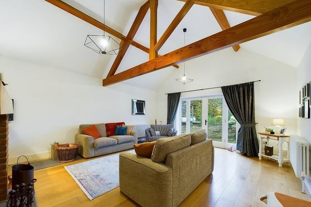 The main lounge has open vaults to the ceiling and French doors leading outside.