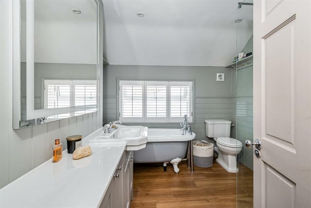 A stylish bathroom with free standing bath and walk in shower.