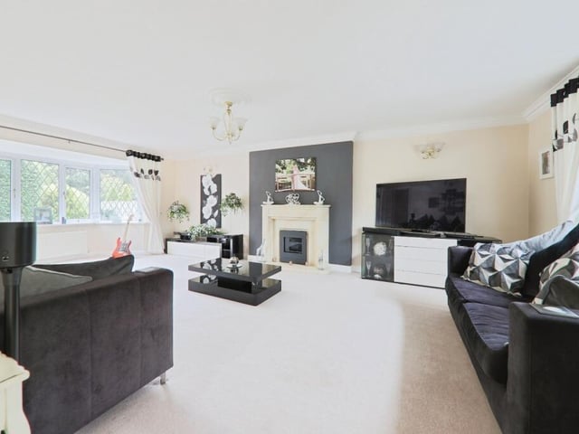 A bright and spacious living room with feature fireplace.