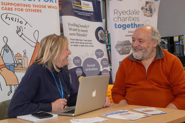 Heather Witty, Ryedale Carers Support coordinator, chatting to library visitor David Swann about the services on offer.
