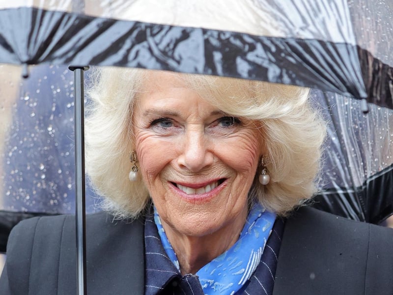 Queen Consort Camilla smiles for the camera.