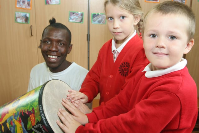 Brigg infants pupils Kieran Hopkinson, Shianne Crowder get music lessons from Zimbabwen visitor Mqoqi Mxhe Nkomo.