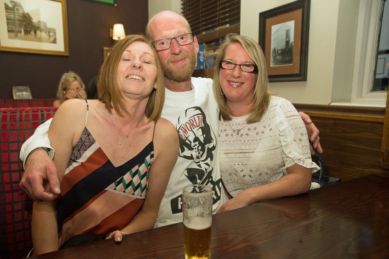 Scott enjoys a cuddle and a drink with Karen & Emma in The Dickens Bar & Inn.