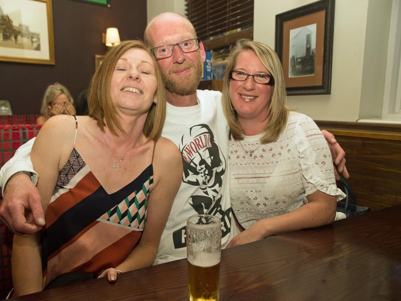 Scott enjoys a cuddle and a drink with Karen & Emma in The Dickens Bar & Inn.