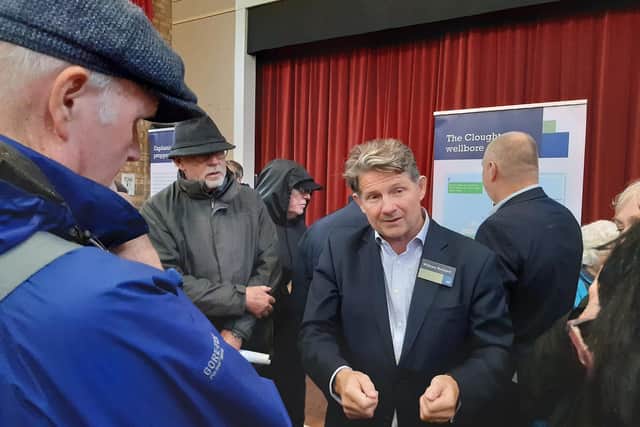 Europa CEO William Holland speaks with residents.