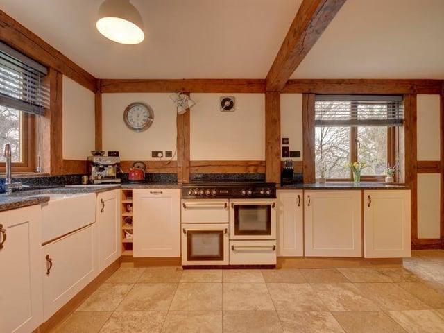 The farmhouse style kitchen has a range oven.