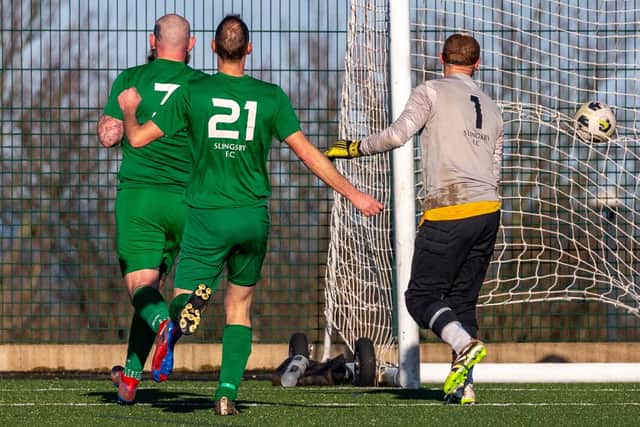 The Slingsby keeper and defenders look back as the second Fishermen's Society goal goes in. Photo by Brian Murfield