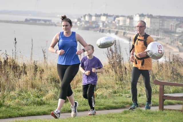 Kirsten Porter, blue top, runs with Alfie who completed his 50th Park run