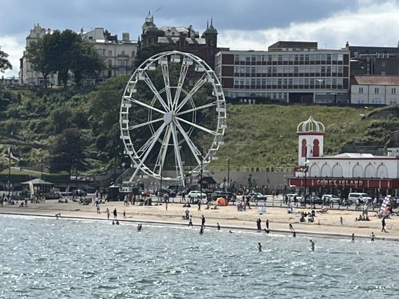 Scarborough beach is busy in the summer sun.