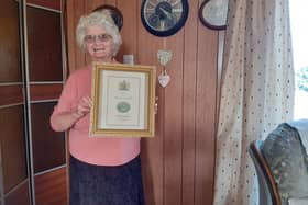 Ada Roe, who was presented with Maundy money by the Queen, pictured with a framed commemorative certificate.