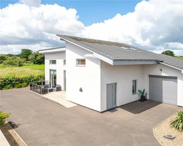 A view of the striking property, with countryside stretching behind.