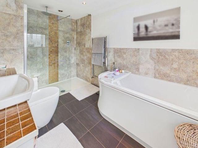 One of two modern bath and shower rooms.