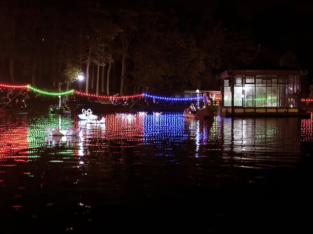 Lights illuminate the lake.