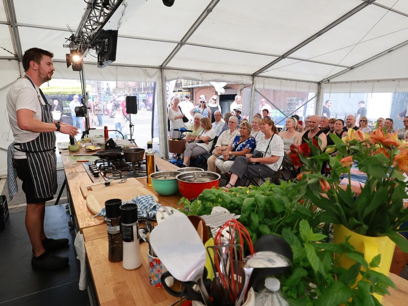 Chef Dan Hargreaves at the food exhibition tent with guests.
